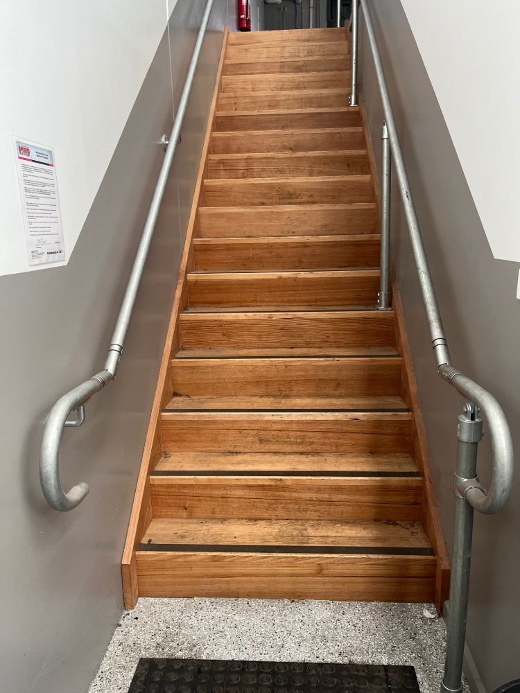 Interclamp DDA compliant handrail system installed on the stairs of a mezzanine floor